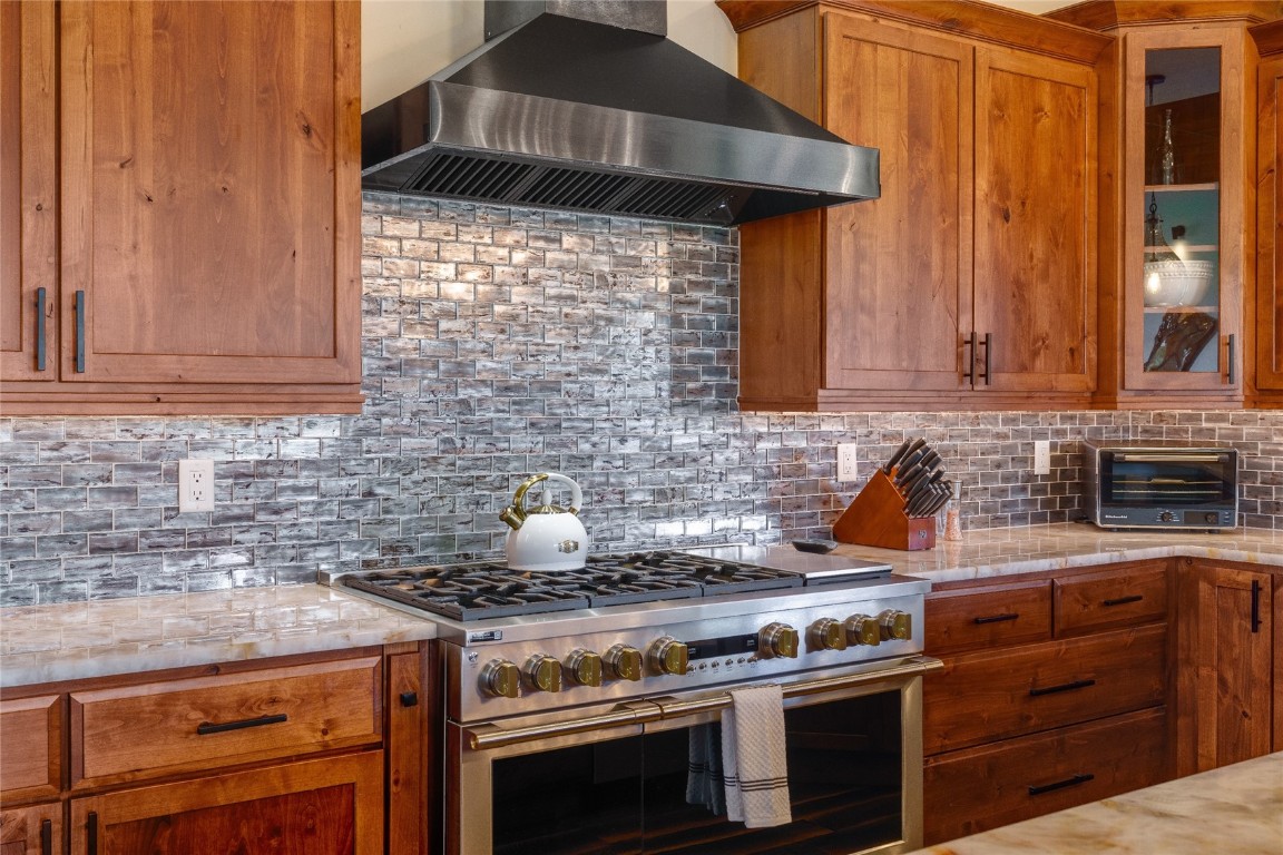2669 Bronc Buster Loop Steamboat Springs, CO 80487 - Photo 13 of 49 a kitchen with stainless steel appliances a stove and a cabinets