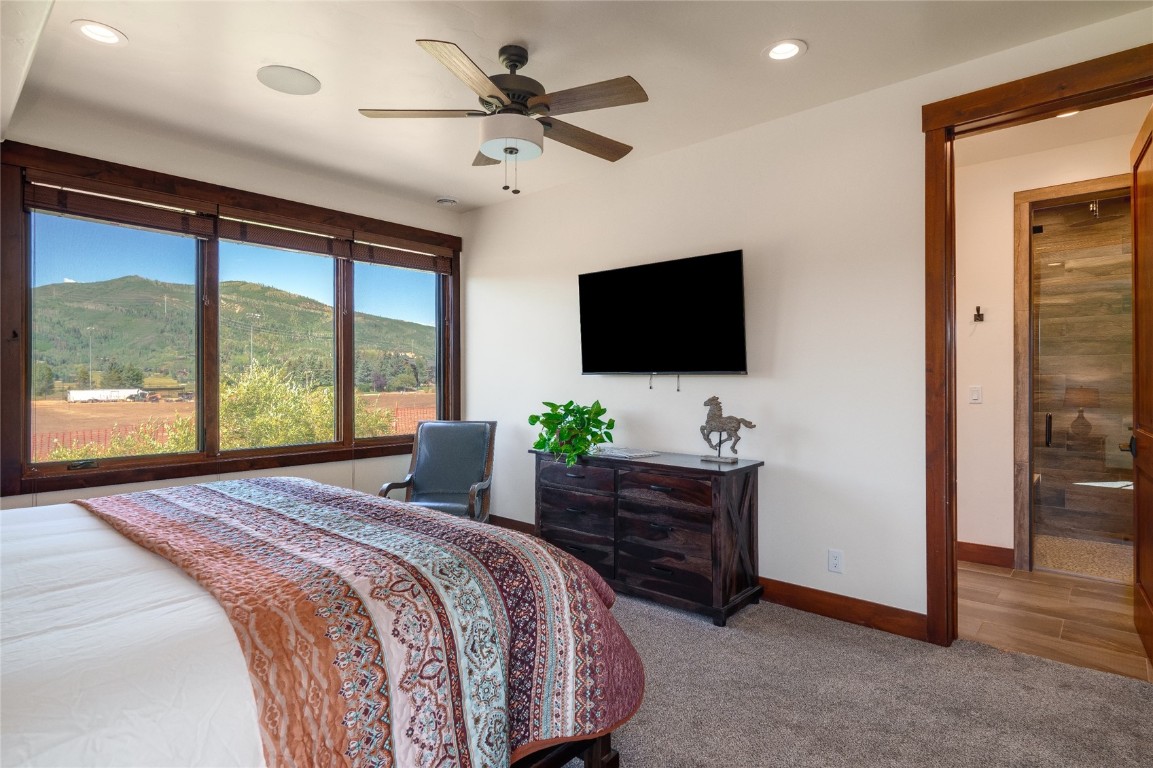 2669 Bronc Buster Loop Steamboat Springs, CO 80487 - Photo 24 of 49 a bedroom with a bed and a flat screen tv