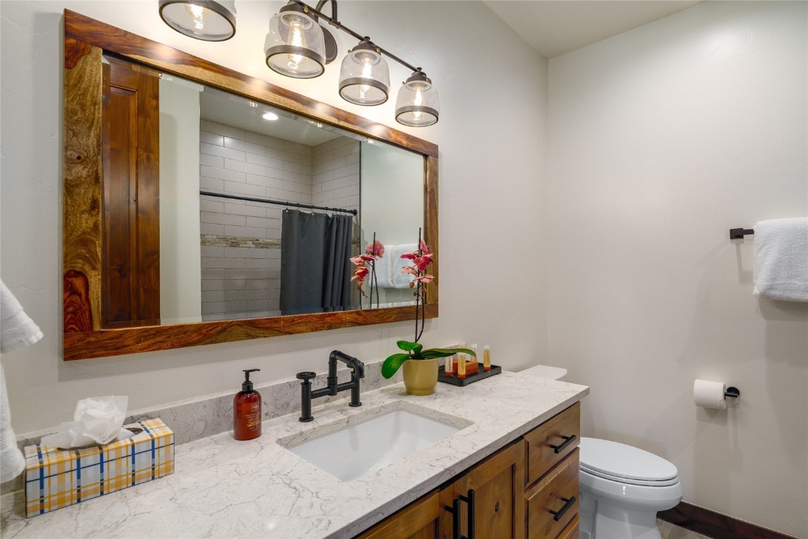 2669 Bronc Buster Loop Steamboat Springs, CO 80487 - Photo 28 of 49 a bathroom with a toilet sink and mirror