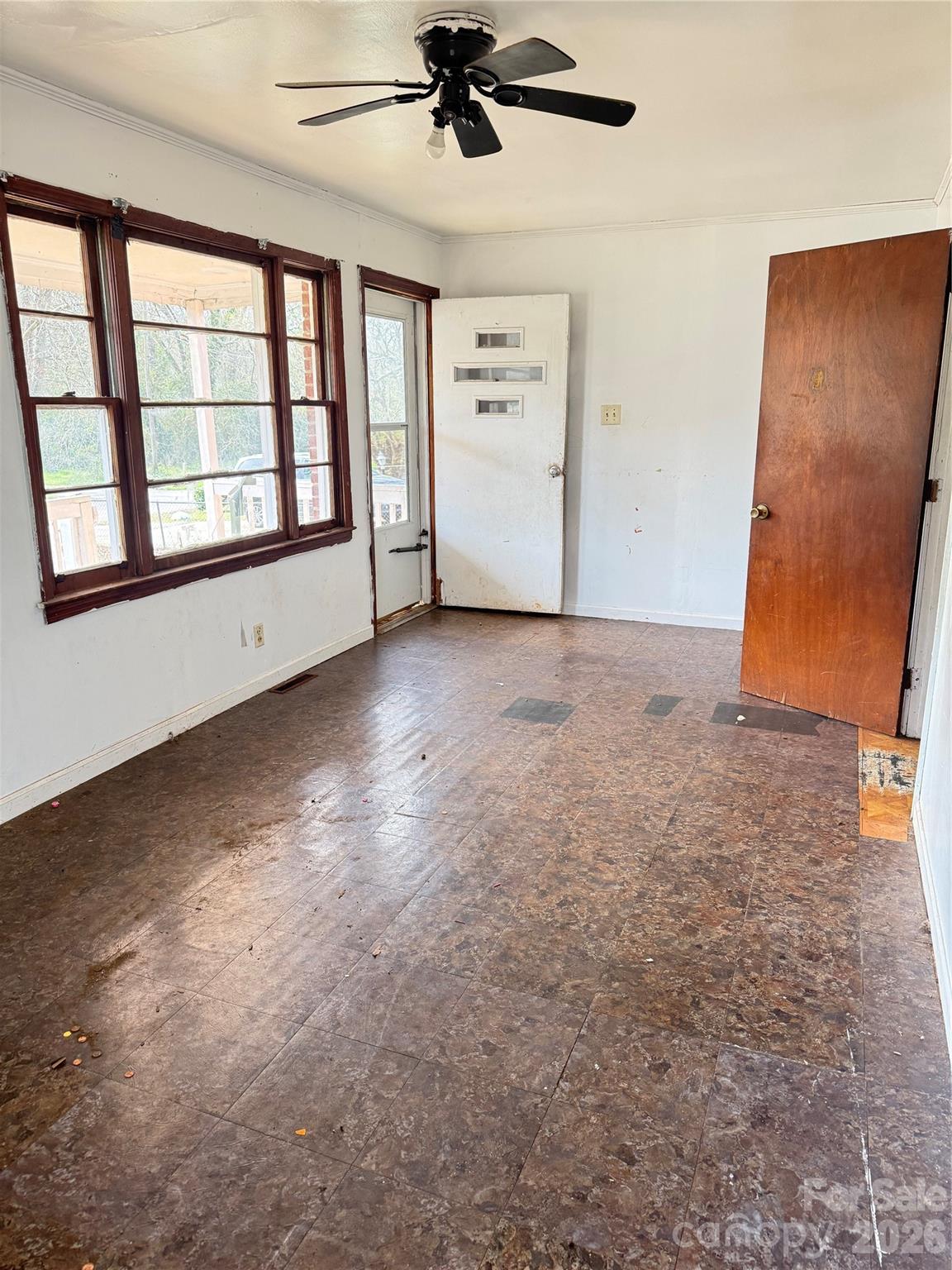 205 Jewel Street Chester, SC 29706 - Photo 3 of 20 an empty room with windows and ceiling fan view
