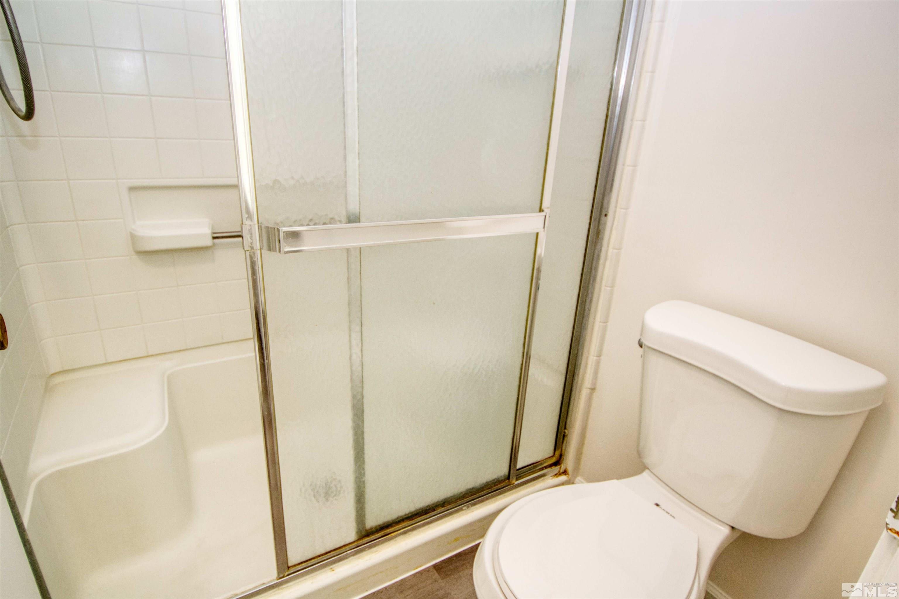 345 H Street Sparks, NV 89431 - Photo 14 of 17 a white toilet sitting next to a shower