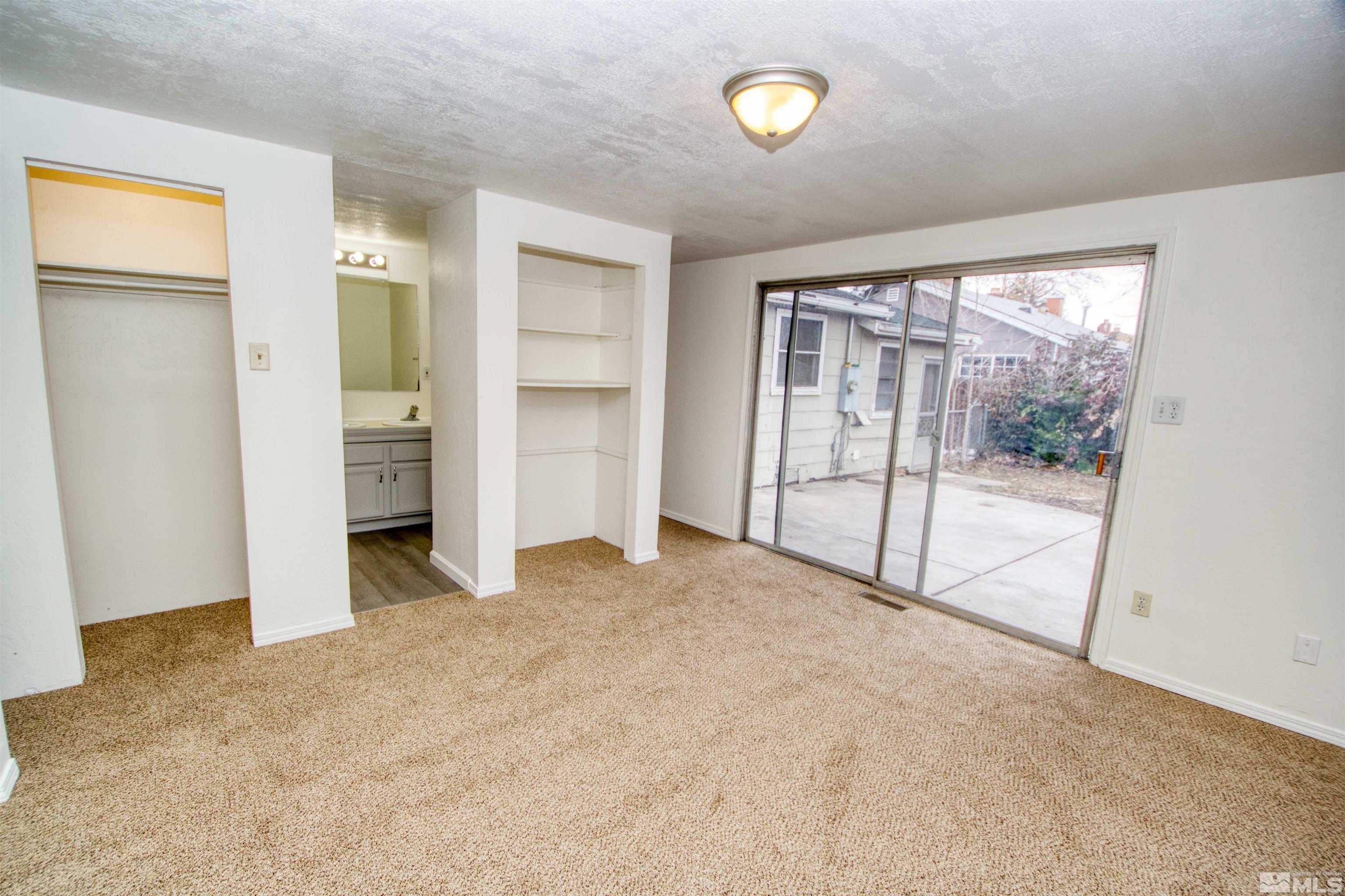 345 H Street Sparks, NV 89431 - Photo 16 of 17 an empty room with a sliding door and wooden floor