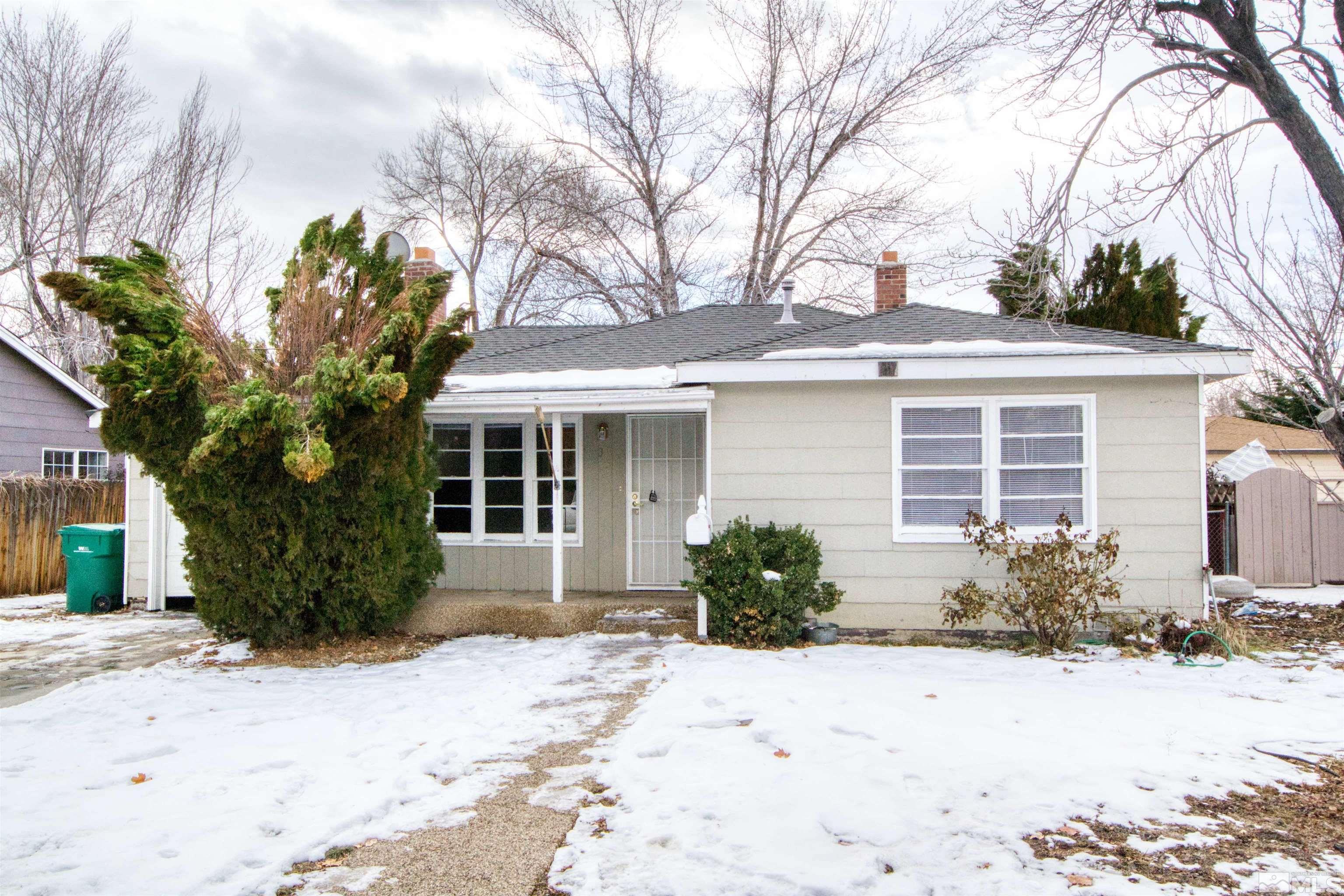 345 H Street Sparks, NV 89431 - Photo 2 of 17 a front view of a house with garden