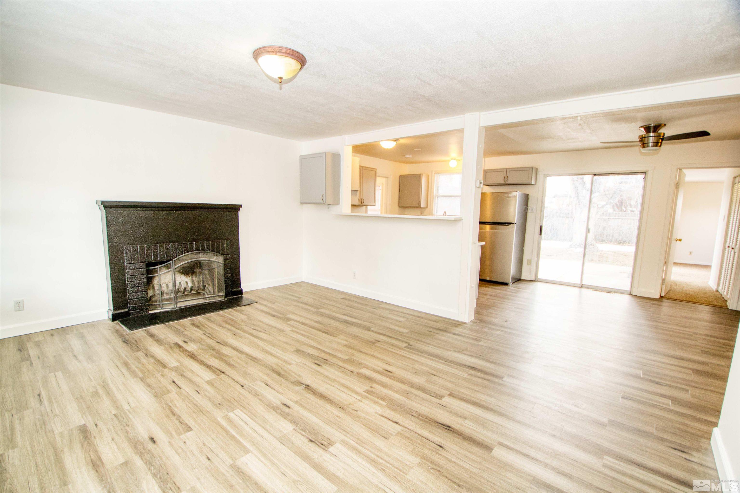 345 H Street Sparks, NV 89431 - Photo 3 of 17 a view of empty room with wooden floor and fan