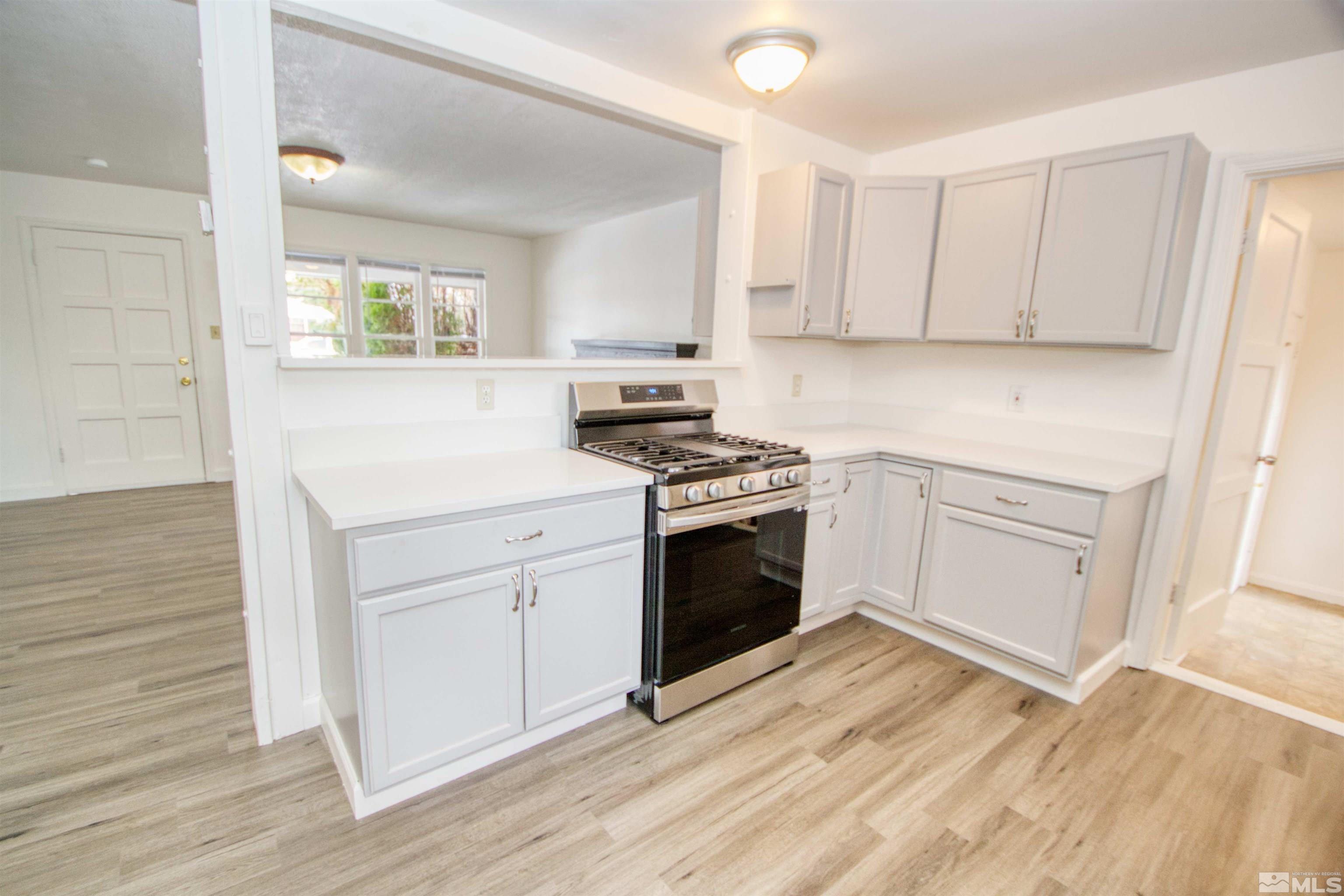 345 H Street Sparks, NV 89431 - Photo 6 of 17 a kitchen with white cabinets and white appliances