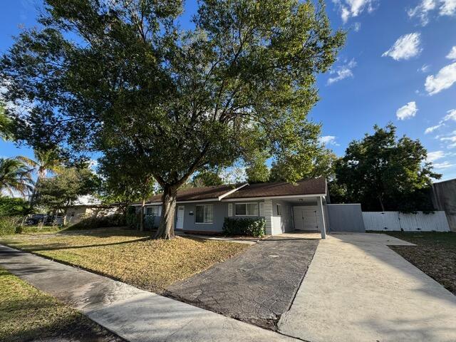 1632 Northwest 5th Street Boca Raton, FL 33486 - Photo 4 of 22 a front view of house with garage and yard