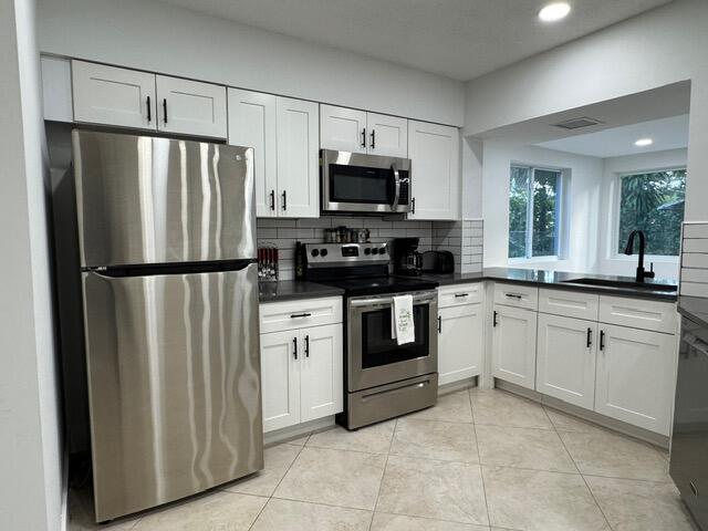 1632 Northwest 5th Street Boca Raton, FL 33486 - Photo 5 of 22 a kitchen with a refrigerator stove and sink