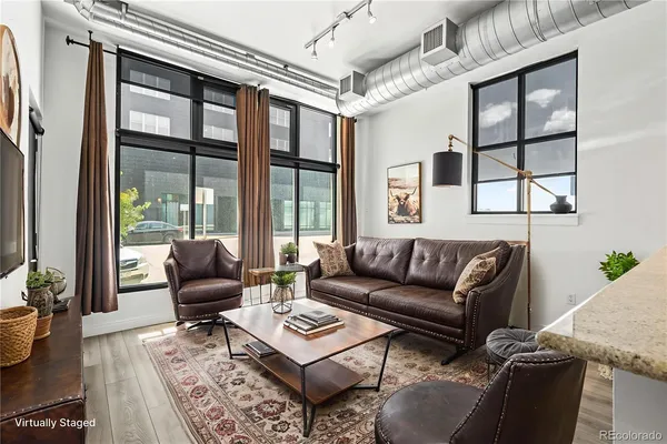 a living room with furniture and a floor to ceiling window
