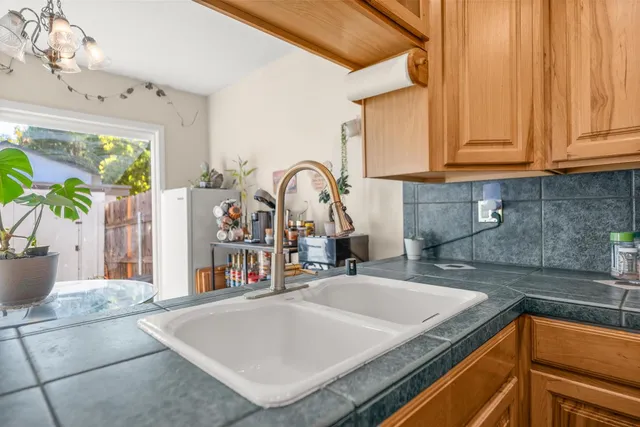 a kitchen with a sink a counter top space and a stove