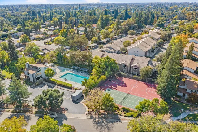 an aerial view of a house with a yard and trees