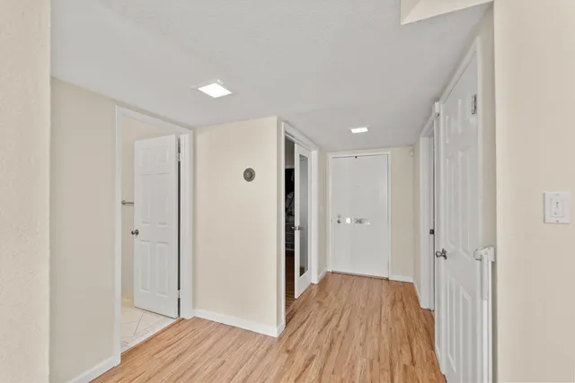 a view of a hallway with wooden floor