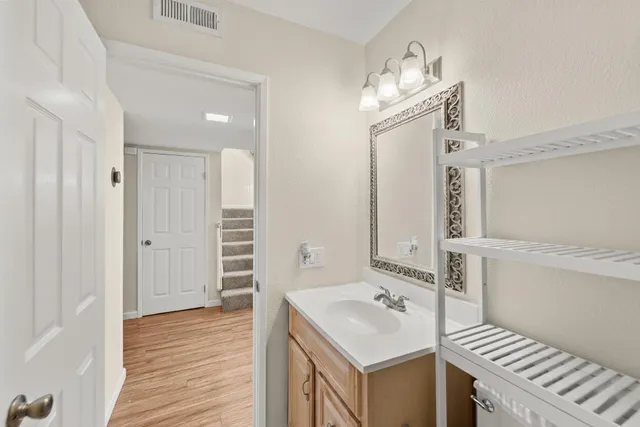 a bathroom with a sink a mirror and a shower