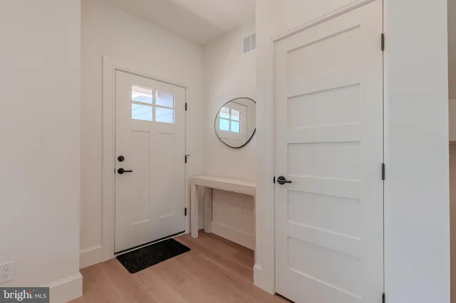 a room with a mirror and a wooden floor