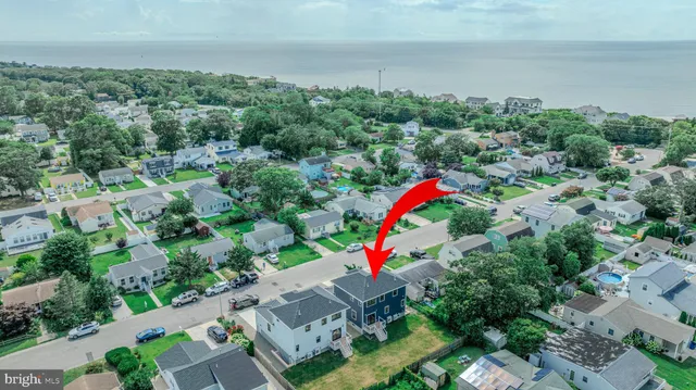 an aerial view of house with outdoor space and swimming pool