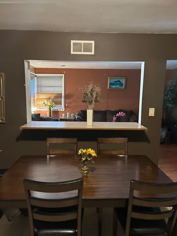 a dining room with furniture and wooden floor