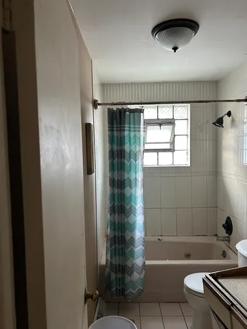 a bathroom with a bathtub and shower