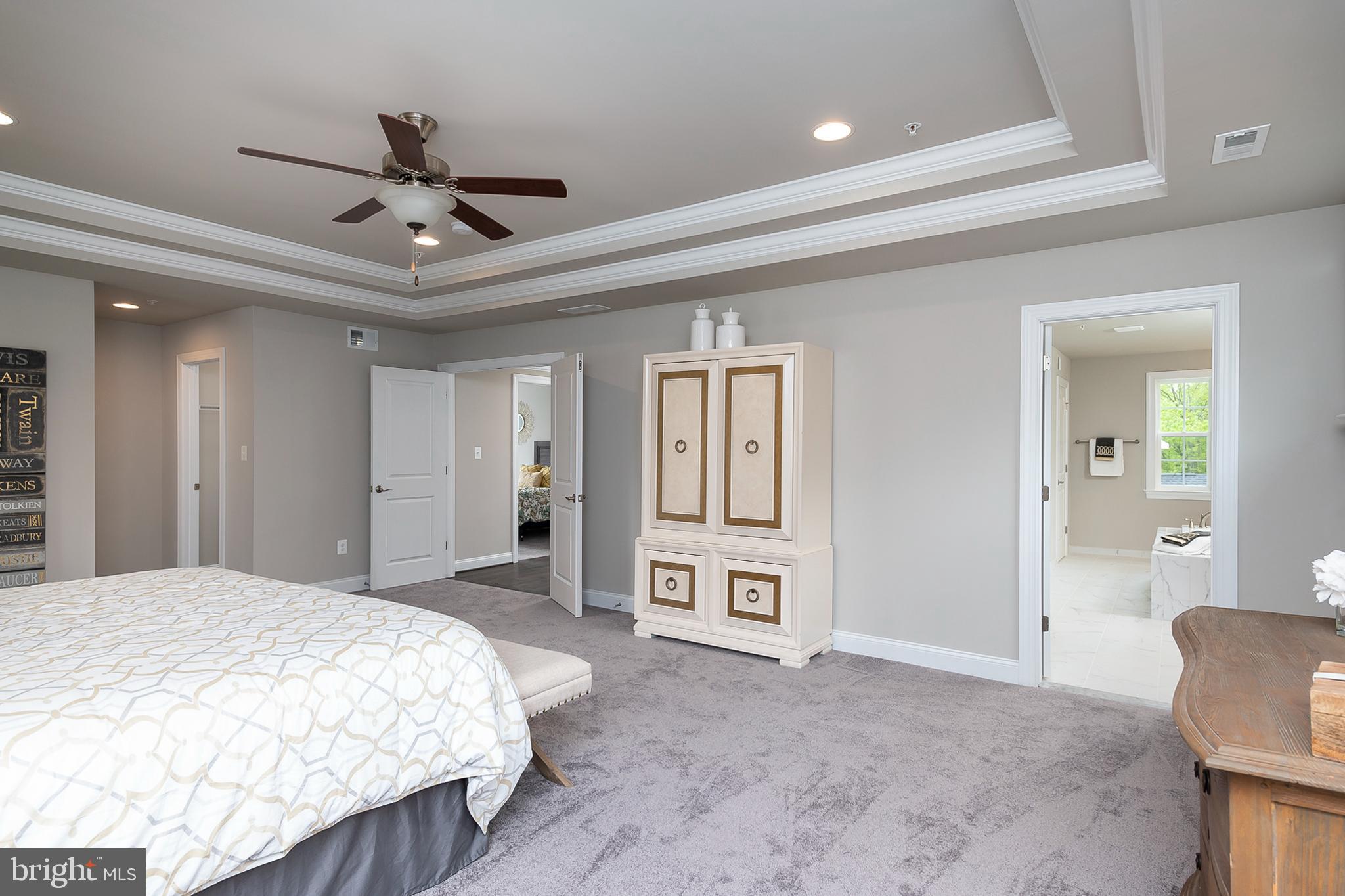 4468 Ilchester Road Ellicott City, MD 21043 - Photo 13 of 32 a spacious bedroom with a balcony a bed and a chandelier