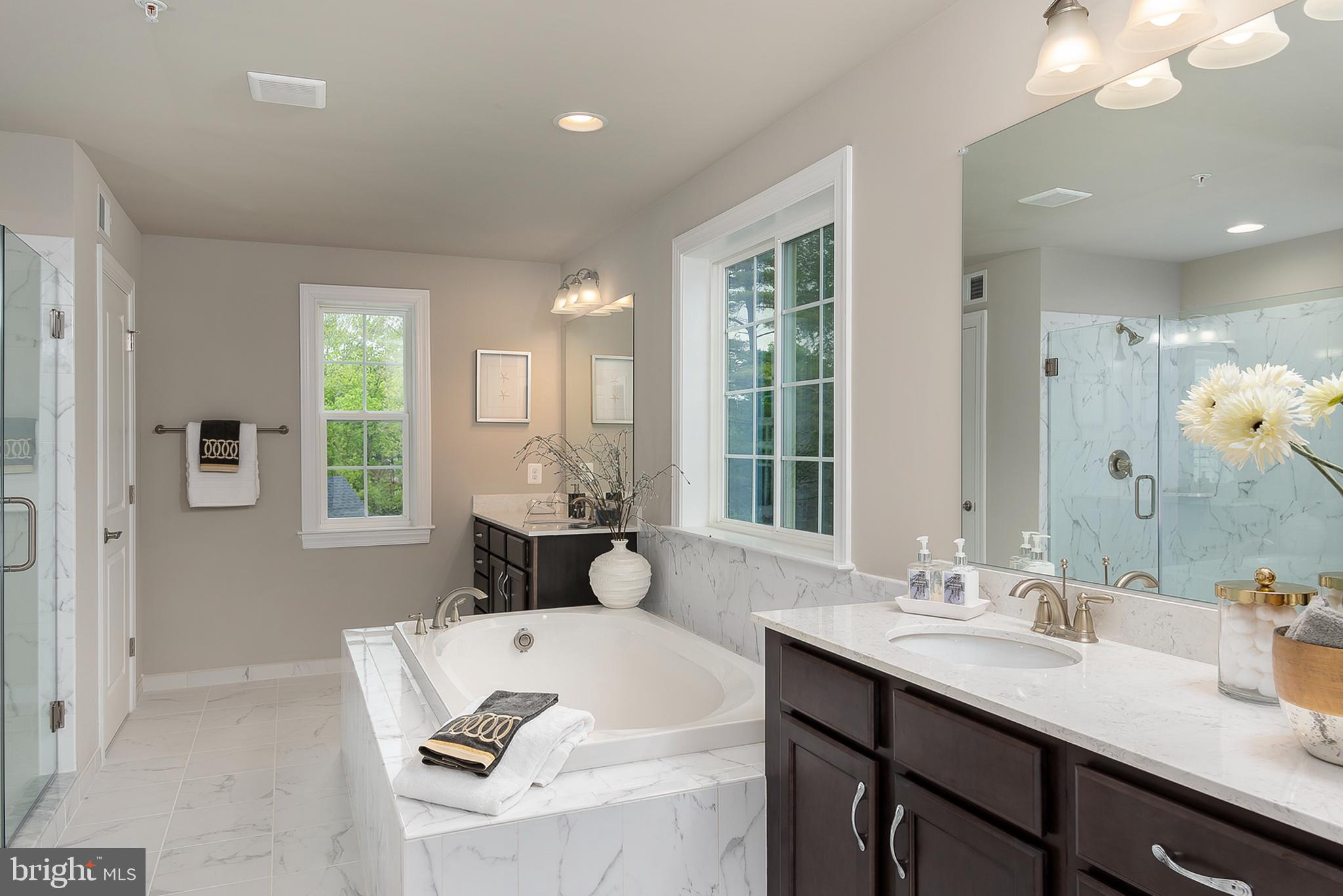 4468 Ilchester Road Ellicott City, MD 21043 - Photo 19 of 32 a bathroom with a tub sink and mirror