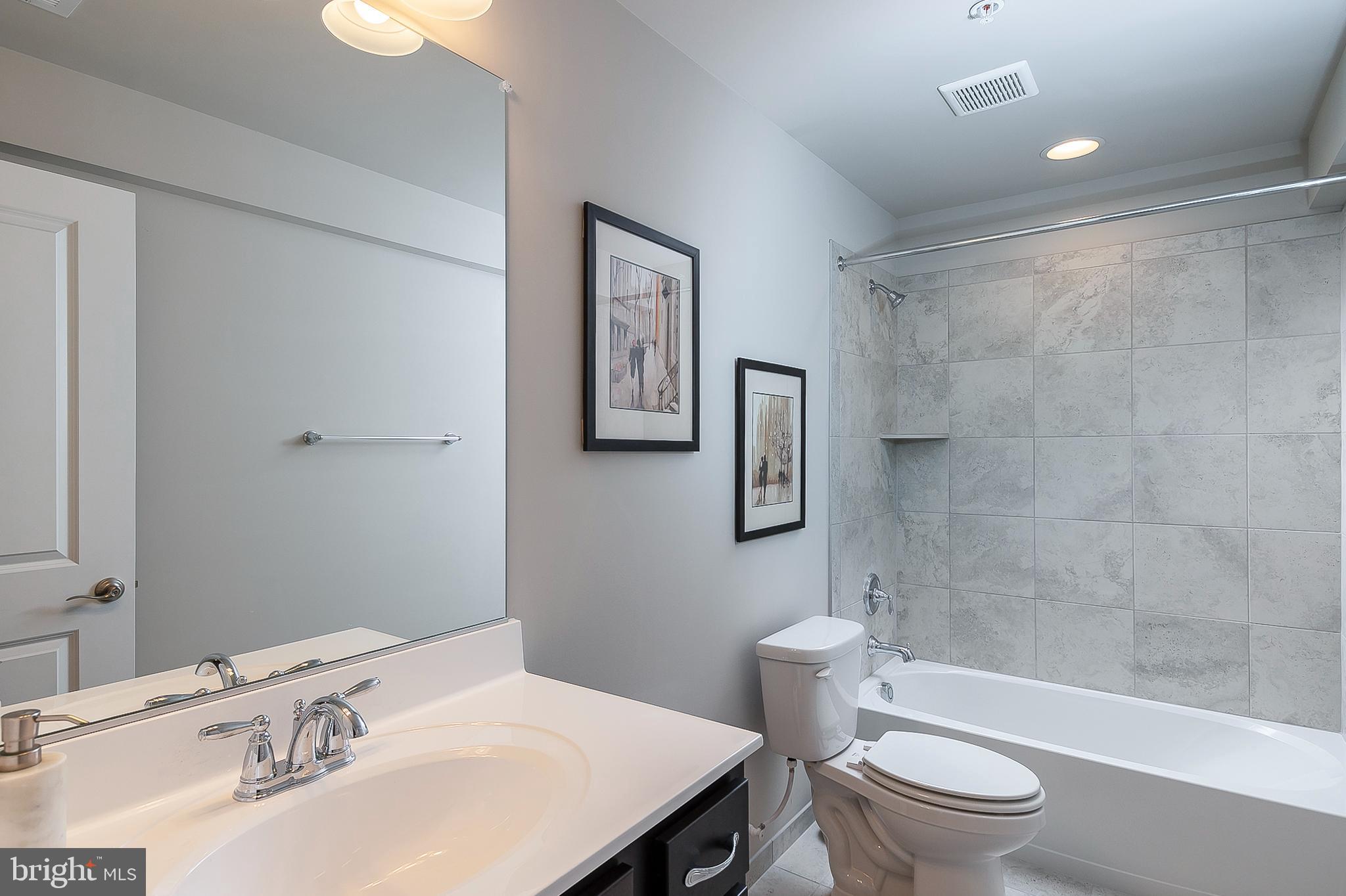 4468 Ilchester Road Ellicott City, MD 21043 - Photo 20 of 32 a bathroom with a sink toilet and shower