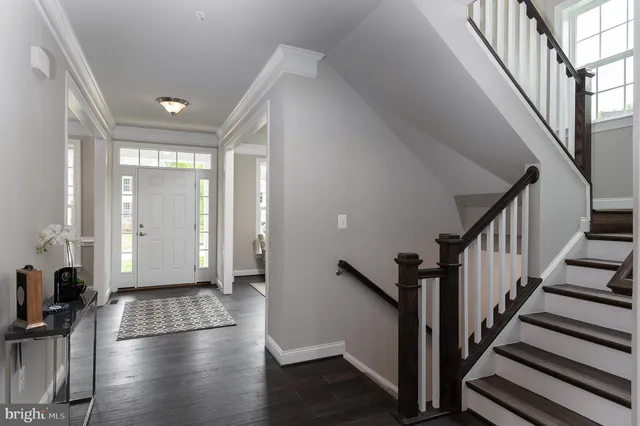 a view of an entryway with wooden floor and door