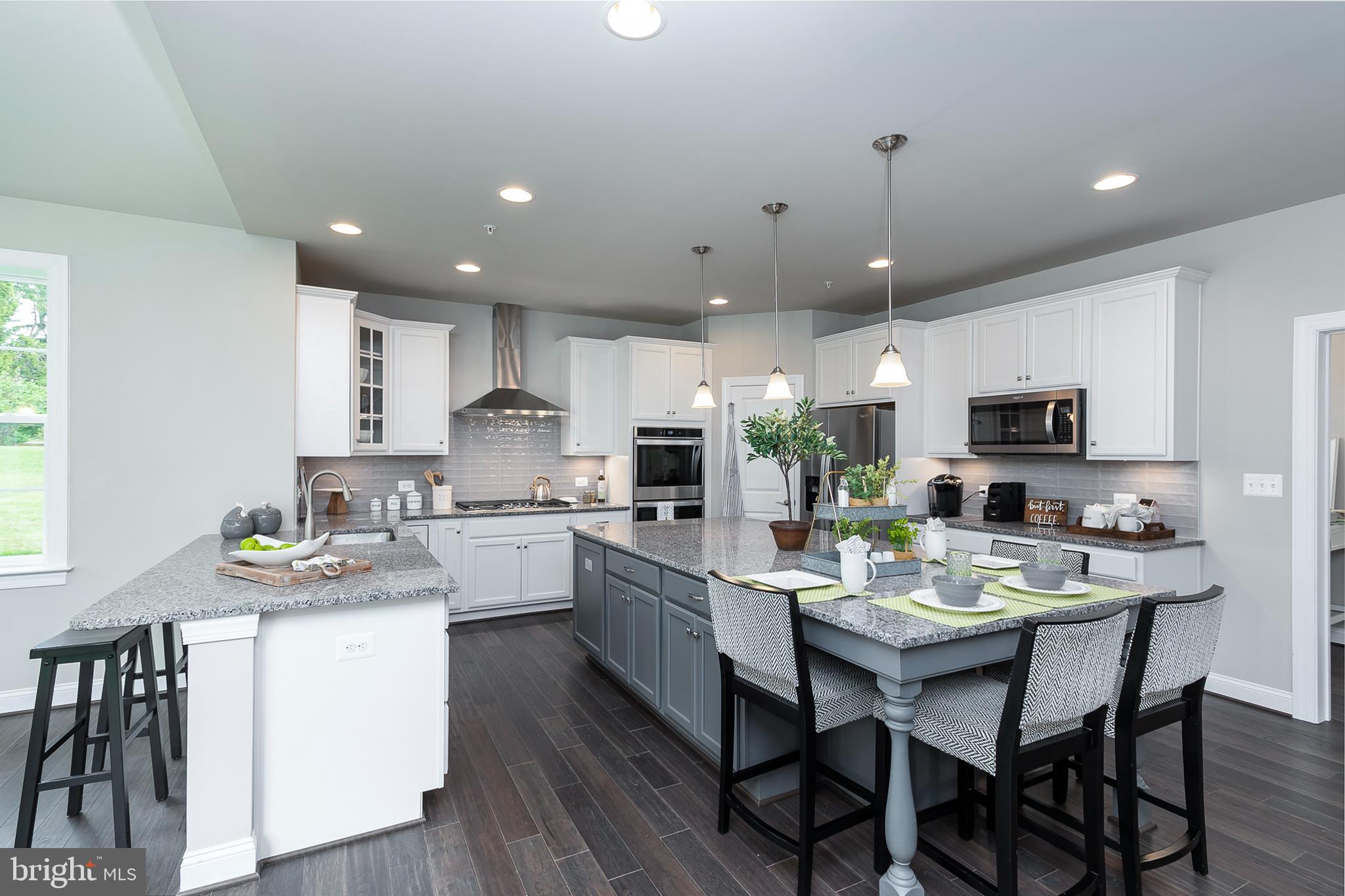 4468 Ilchester Road Ellicott City, MD 21043 - Photo 25 of 32 a kitchen with a sink white cabinets and stainless steel appliances