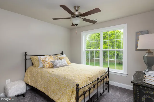 a bedroom with a bed dresser and a window