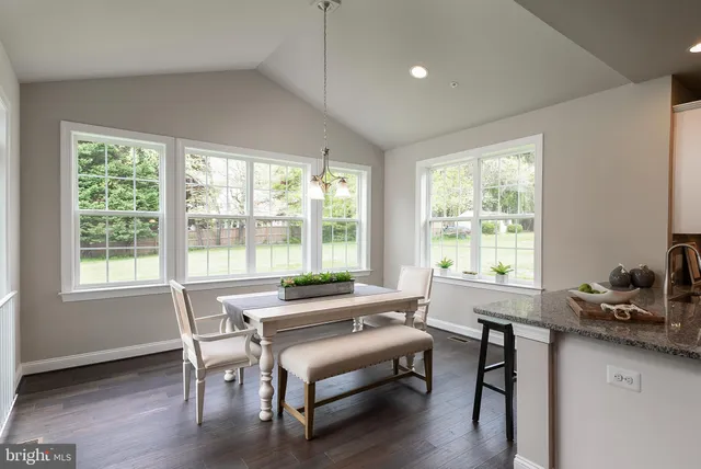 a workspace with wooden floor and a window