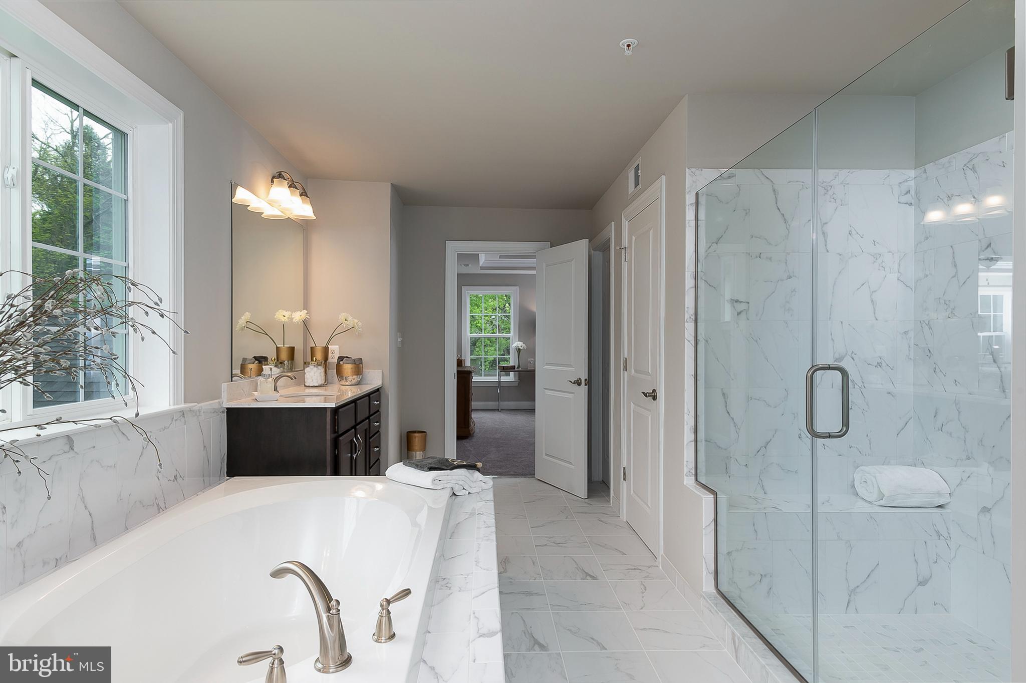 4468 Ilchester Road Ellicott City, MD 21043 - Photo 4 of 32 a large bathroom with a tub sink shower and mirror