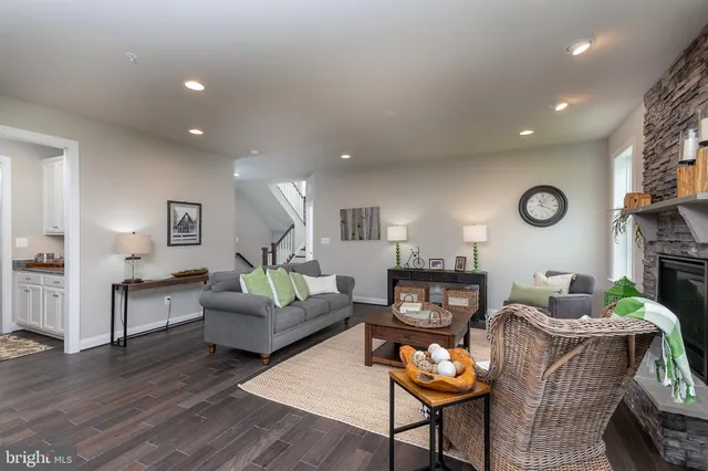 a living room with fireplace furniture and wooden floor