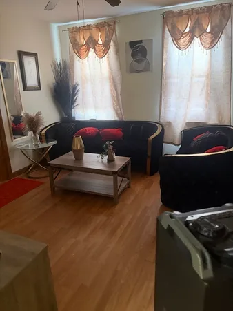 a room with wooden floor and furniture