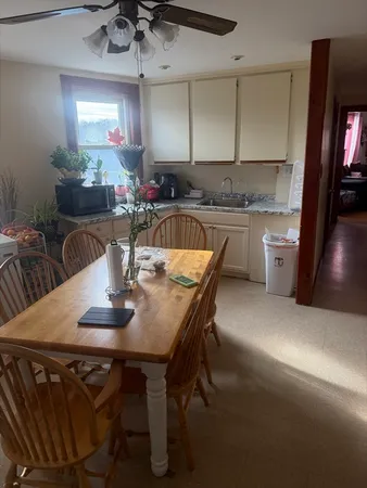 a kitchen with a table chairs stove and cabinets