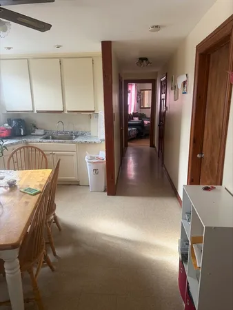 a kitchen with a sink refrigerator and cabinets
