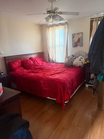 a bedroom with a bed and a window