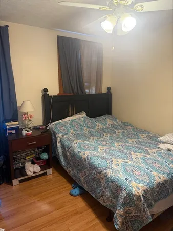 a bedroom with a bed and a mirror