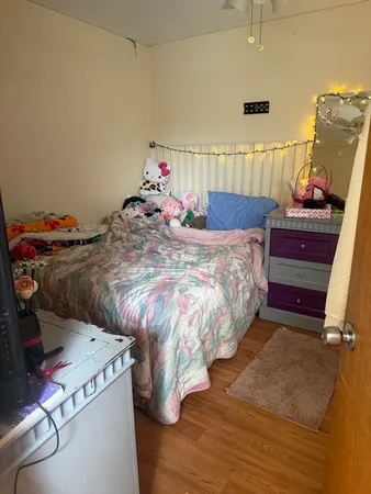 a bed sitting in a bedroom next to a window