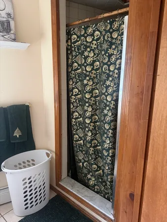 a bathroom with a bathtub and shower