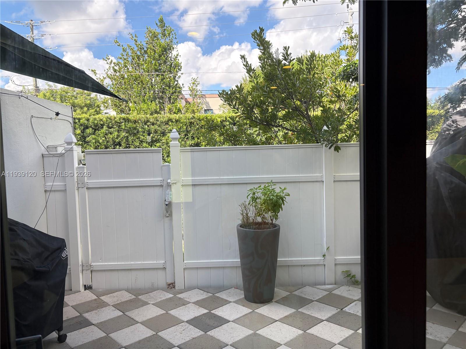 5555 Ludlam Road, Unit 105 South Miami, FL 33155 - Photo 13 of 29 a view of a house with a potted plant