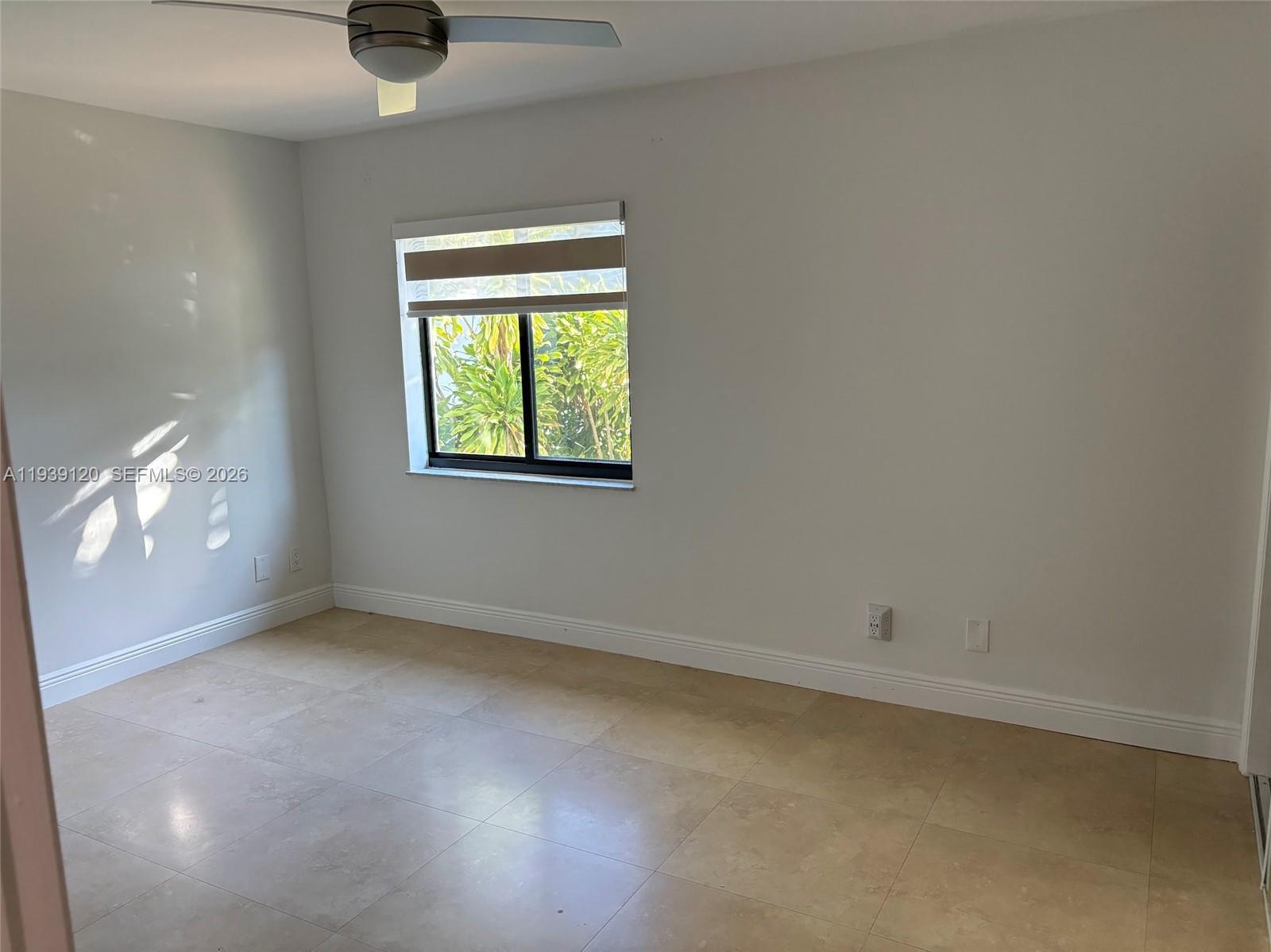 5555 Ludlam Road, Unit 105 South Miami, FL 33155 - Photo 20 of 29 an empty room with a empty space and windows