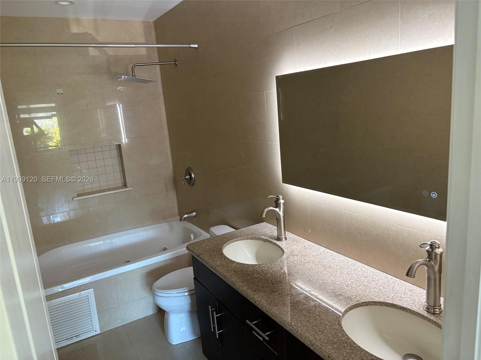 5555 Ludlam Road, Unit 105 South Miami, FL 33155 - Photo 21 of 29 a bathroom with a granite countertop sink toilet and shower