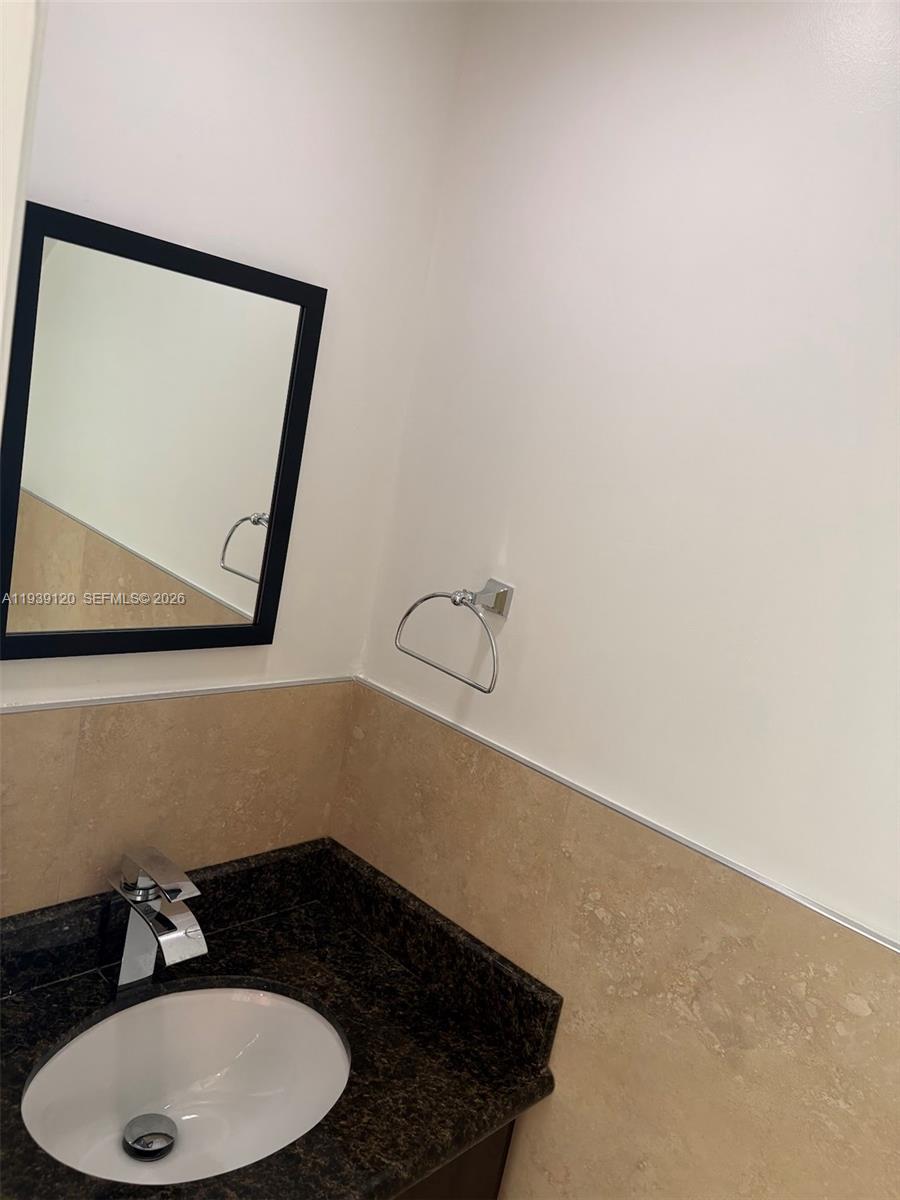 5555 Ludlam Road, Unit 105 South Miami, FL 33155 - Photo 25 of 29 a bathroom with a sink and a mirror