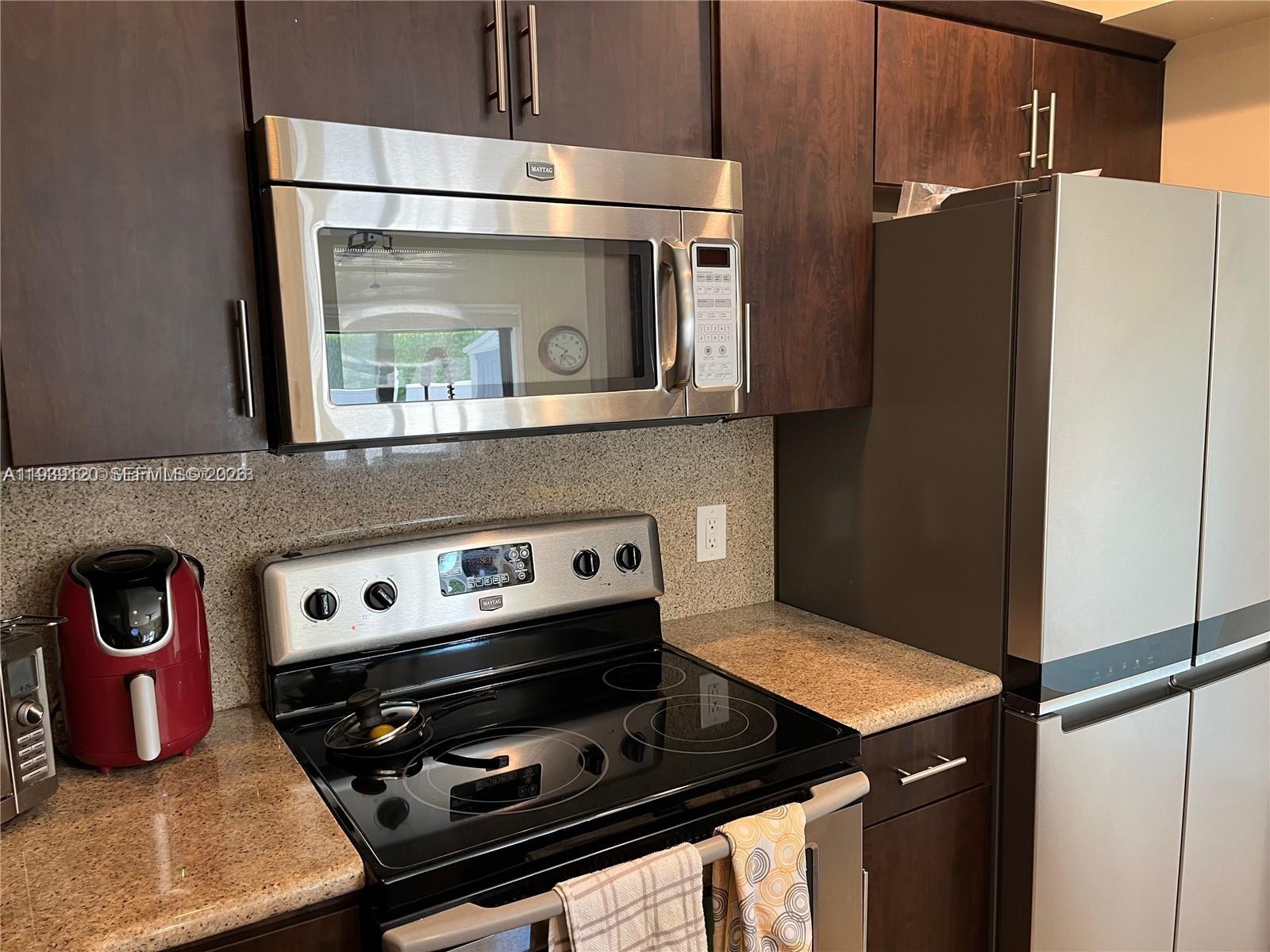 5555 Ludlam Road, Unit 105 South Miami, FL 33155 - Photo 7 of 29 a stove top oven sitting inside of a kitchen