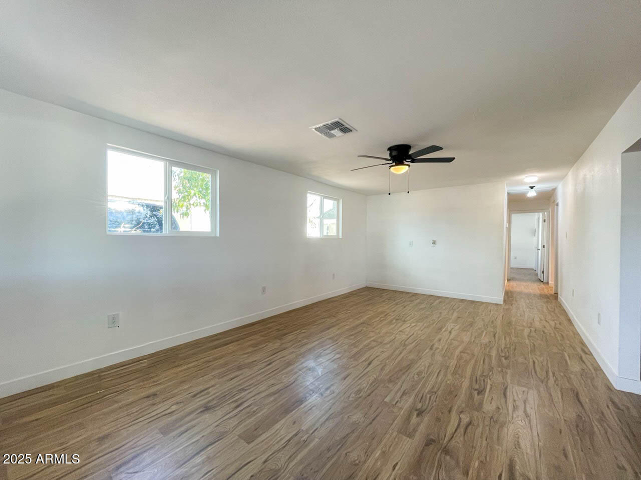 8125 East 5th Avenue Mesa, AZ 85208 - Photo 11 of 46 an empty room with wooden floor and windows