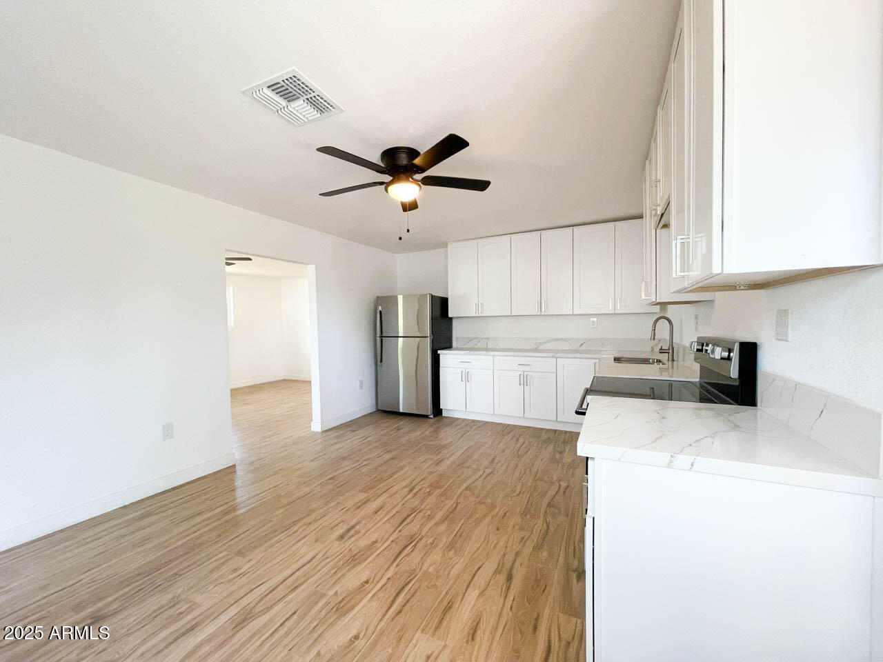 8125 East 5th Avenue Mesa, AZ 85208 - Photo 14 of 46 a view of a kitchen with a sink cabinets and wooden floor
