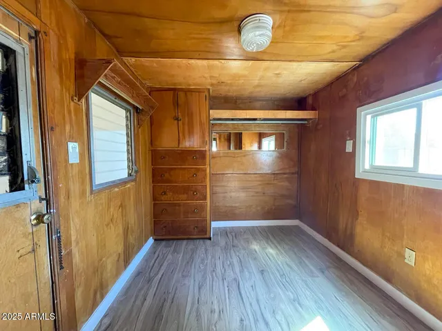 a view of empty room with wooden floor