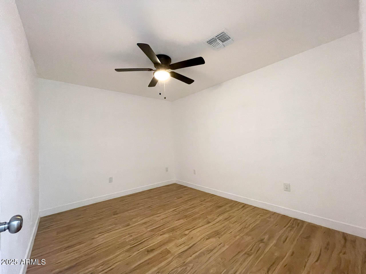 8125 East 5th Avenue Mesa, AZ 85208 - Photo 24 of 46 an empty room with a ceiling fan and a window