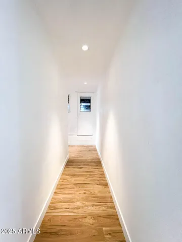 a view of a hallway with wooden floor