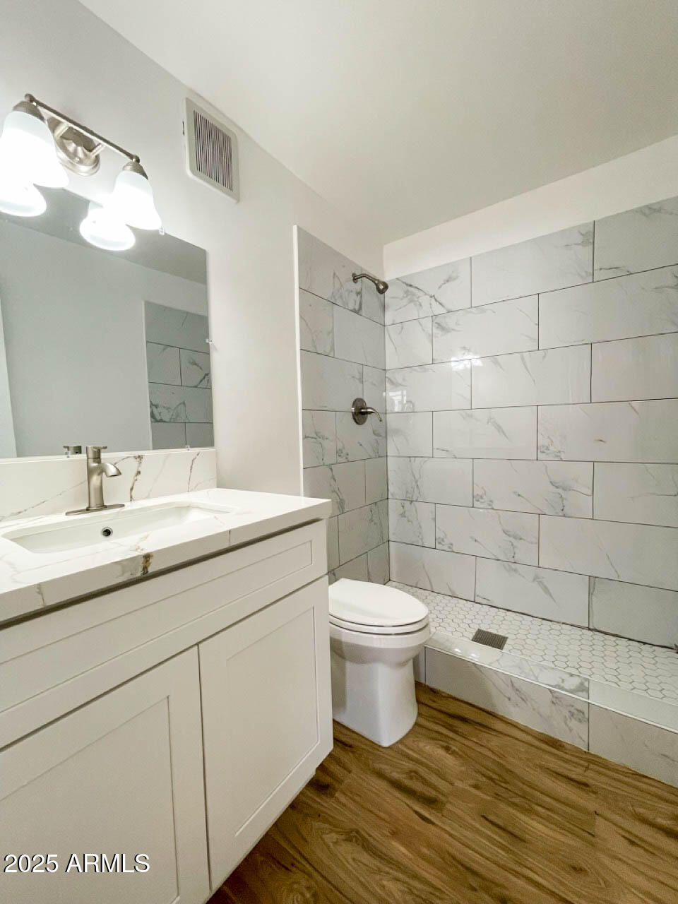 8125 East 5th Avenue Mesa, AZ 85208 - Photo 27 of 46 a bathroom with a toilet a sink and shower