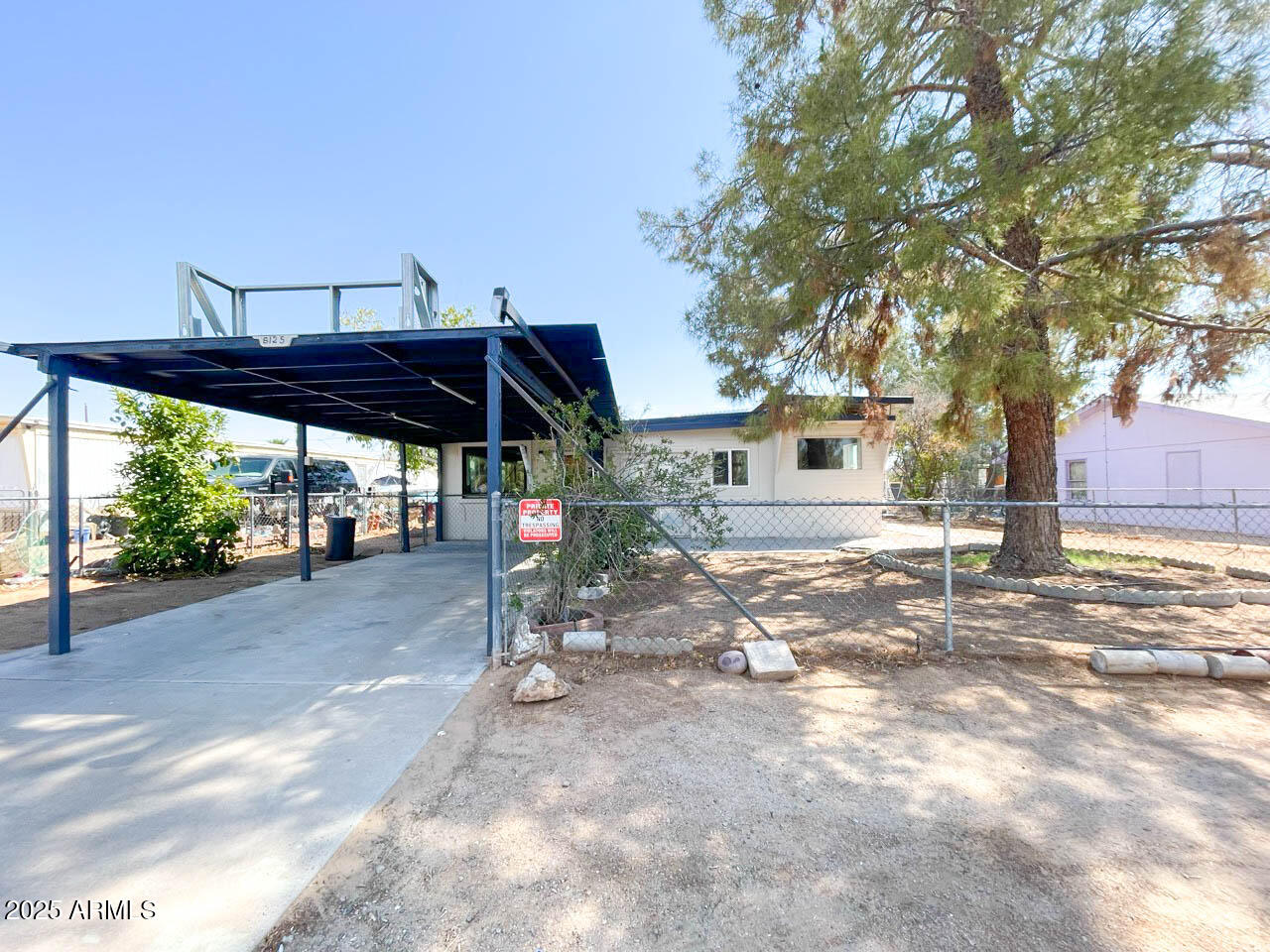 8125 East 5th Avenue Mesa, AZ 85208 - Photo 5 of 46 a view of a patio with a table and chairs under an umbrella
