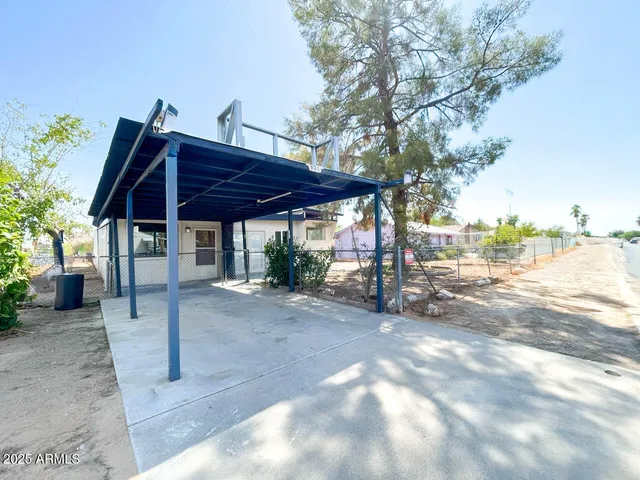 a view of a table and chairs under an umbrella