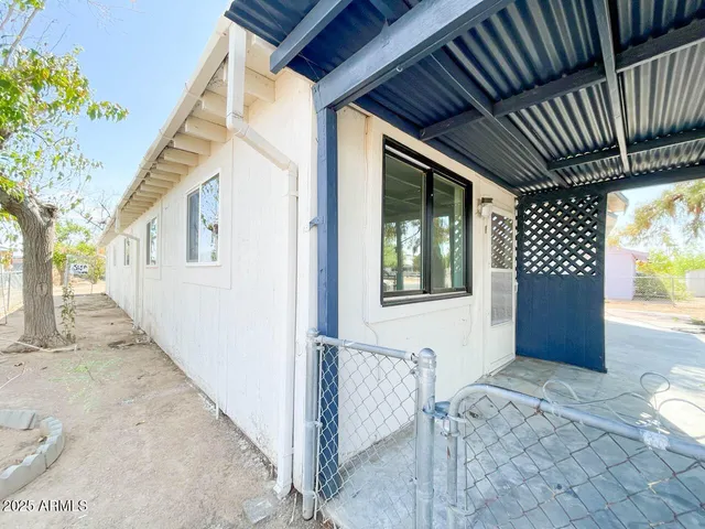 a view of house with backyard and glass door